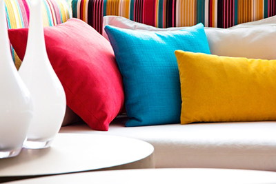 white couch sofa colorful pillows